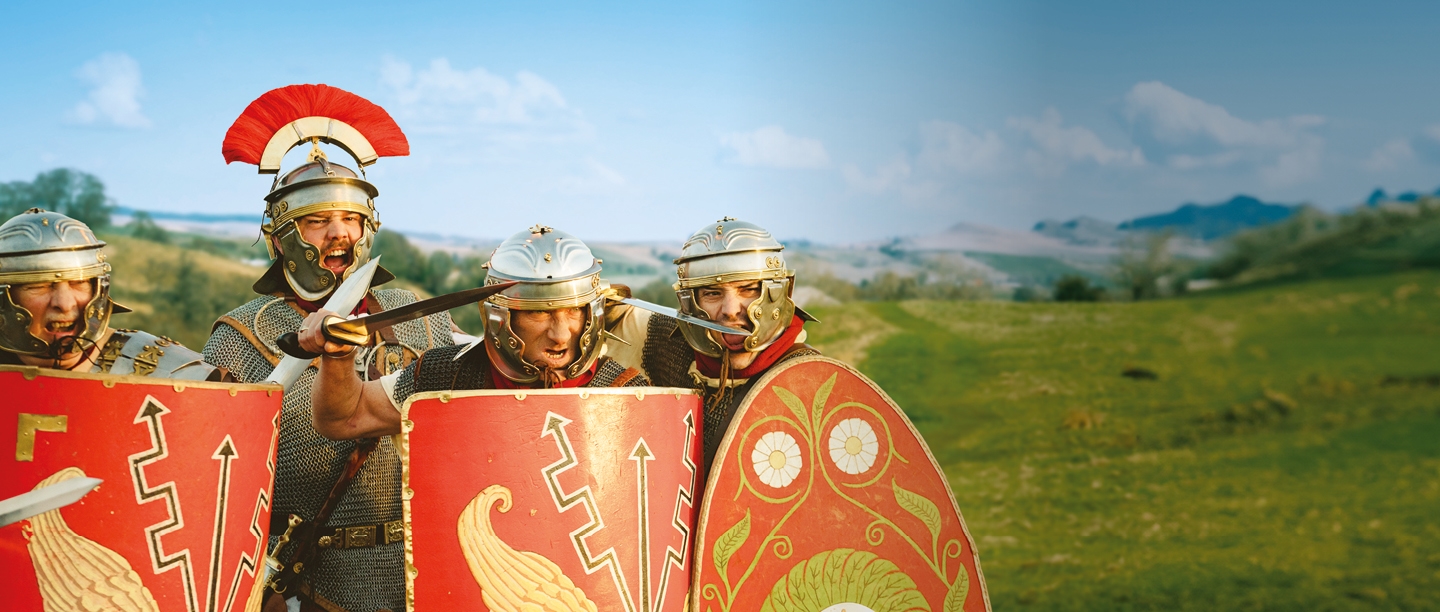 Photo of four people dressed as Roman soldiers 